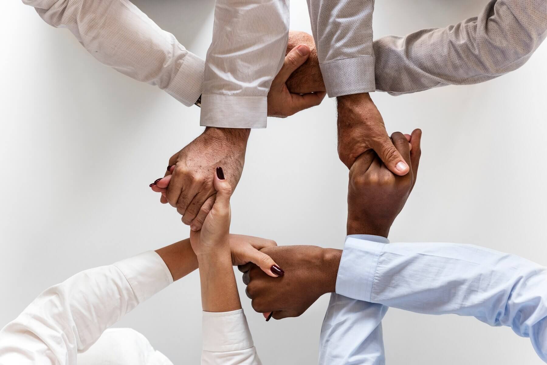 Hands joined together symbolizing teamwork and collaboration towards a shared vision